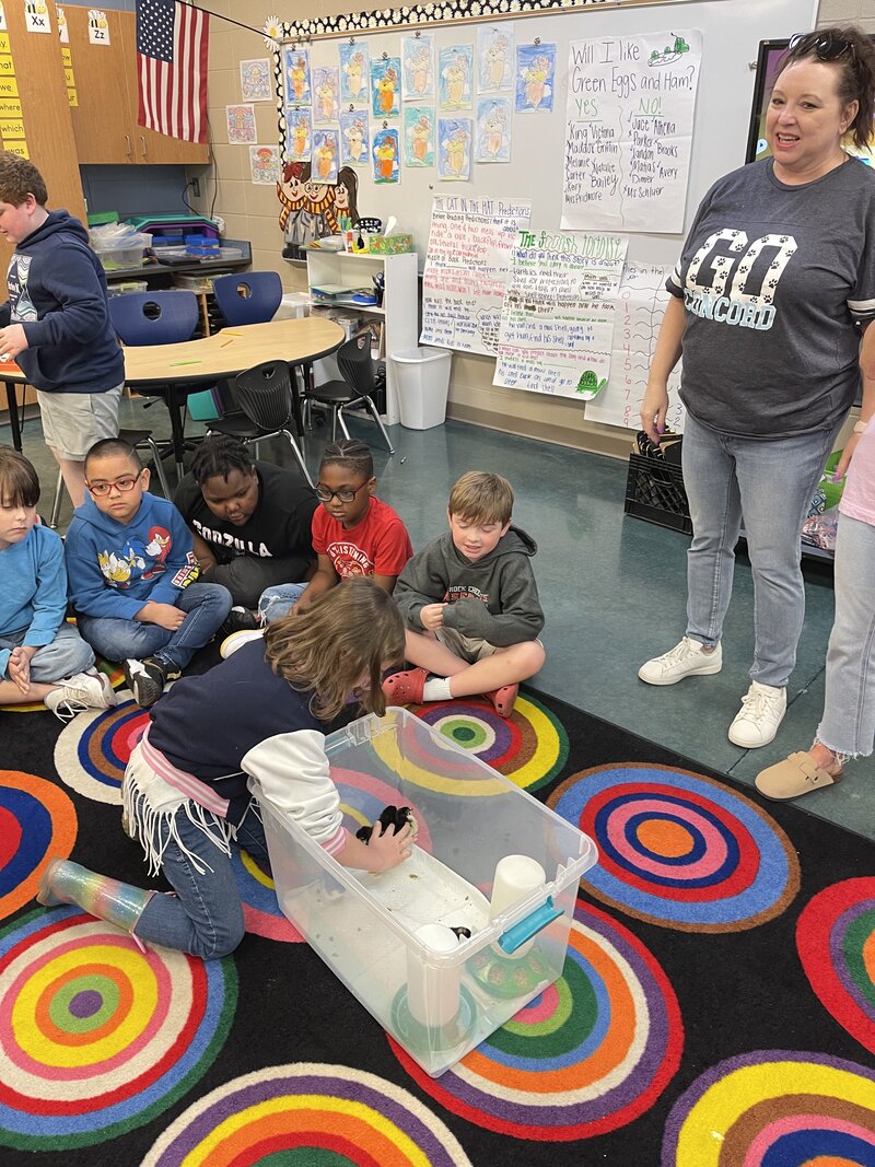 Students checking incubator temperature in the classroom